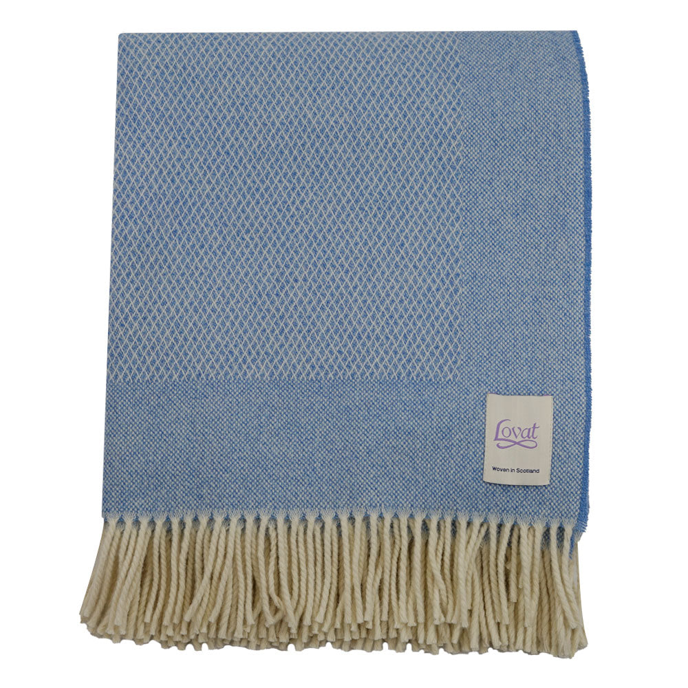 A sky blue diamond border blanket with fringing, crafted from 100% lambswool, displayed on a white background.