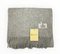 A gray lambswool scarf with fringes, displayed flat with brand tags visible.