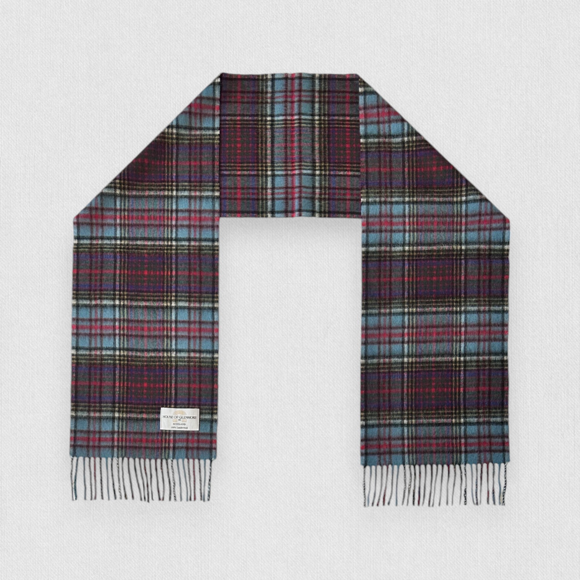 A checkered scarf called Anderson Tartan with shades of blue, green, ivory, with accents of red and yellow, laid out flat.