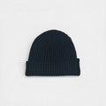 Dark charcoal ribbed cashmere beanie photographed on a white background.