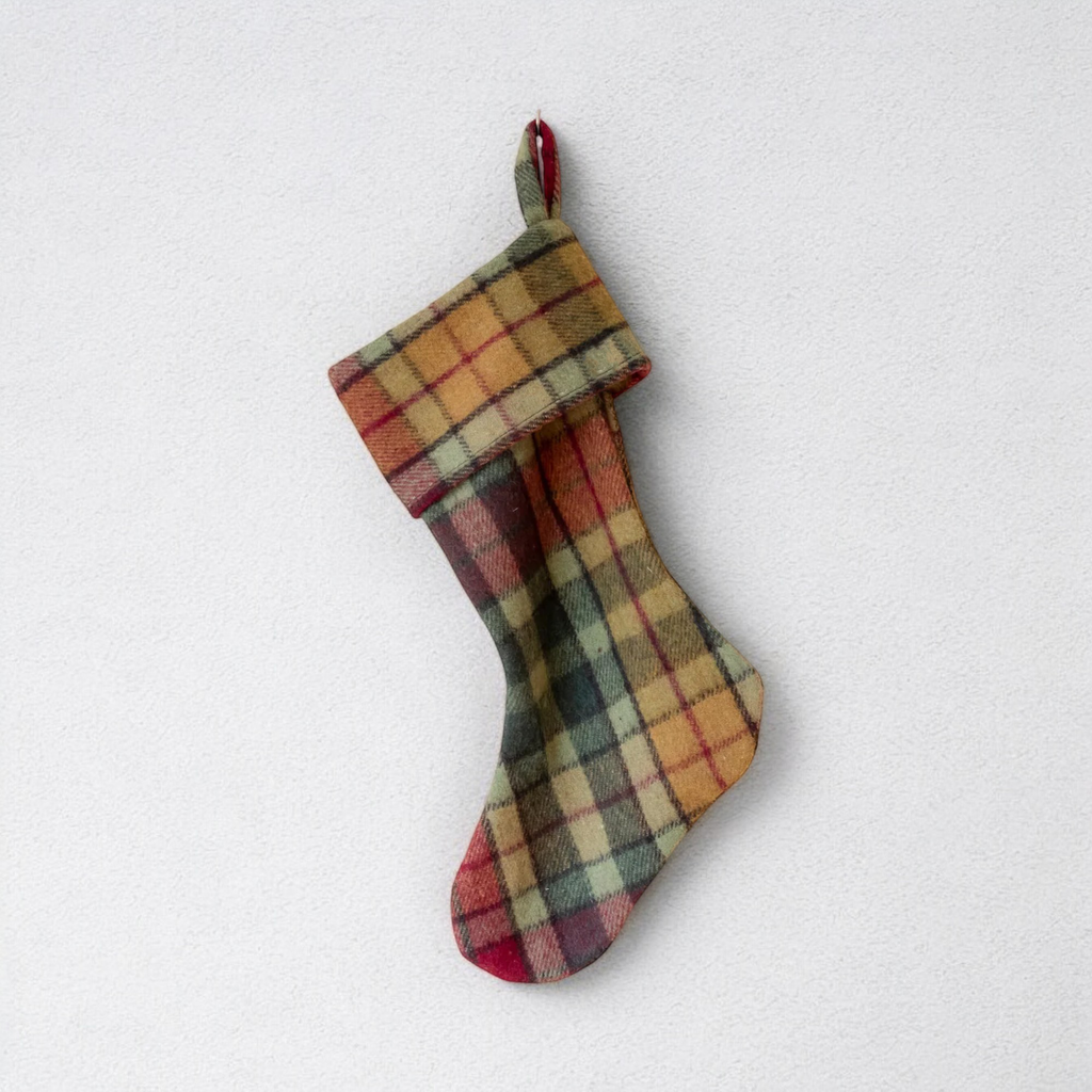 The Autumn Buchanan Christmas Stocking hanging on a white backgorund.