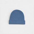 Blue cashmere ribbed beanie on white background.