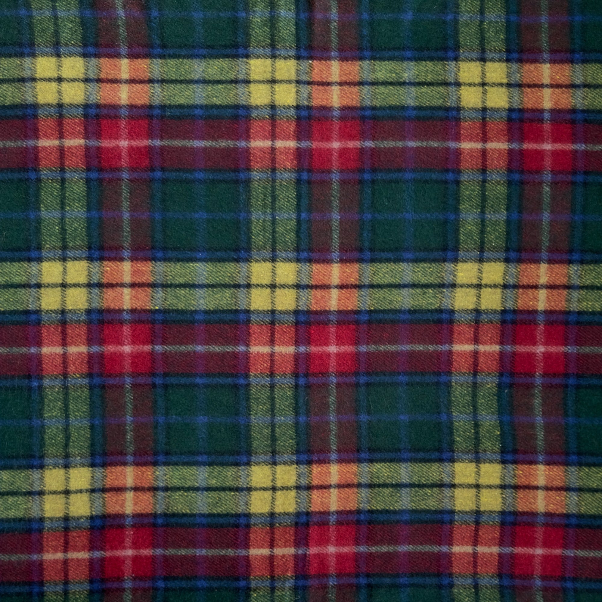 A close up example of the Buchanan Modern tartan. Buchanan Modern tartan has green, yellow, red and white stripes in a checkered pattern.