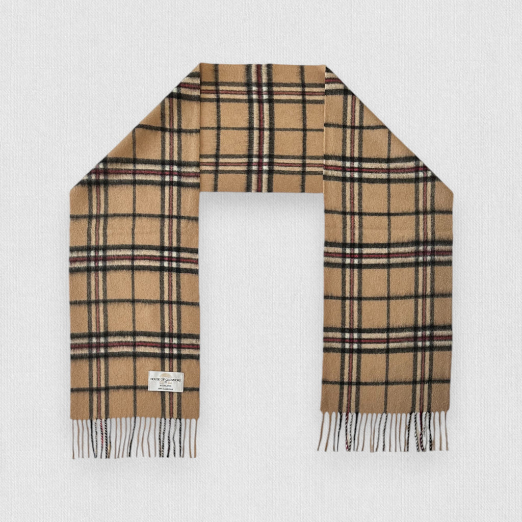A Camel Thomson tartan scarf in beige, black, and red check pattern with fringes, displayed flat.