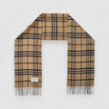 A Camel Thomson tartan scarf in beige, black, and red check pattern with fringes, displayed flat.