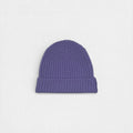 Purple 100% cashmere ribbed beanie on a white background.