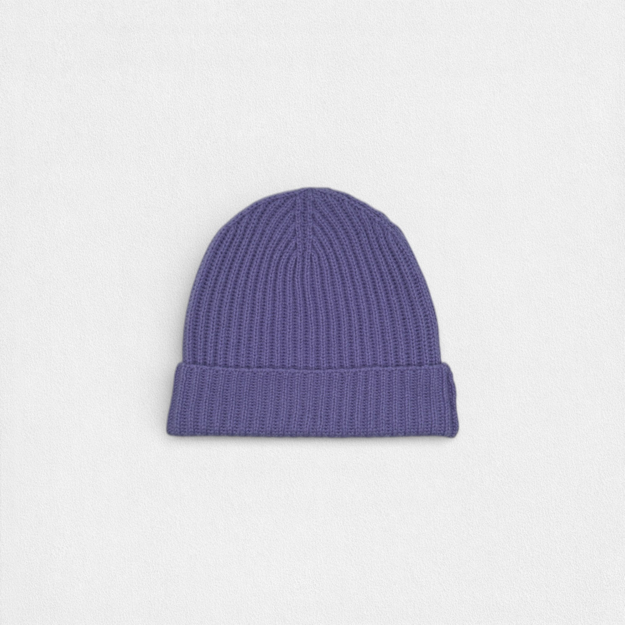 Purple 100% cashmere ribbed beanie on a white background.
