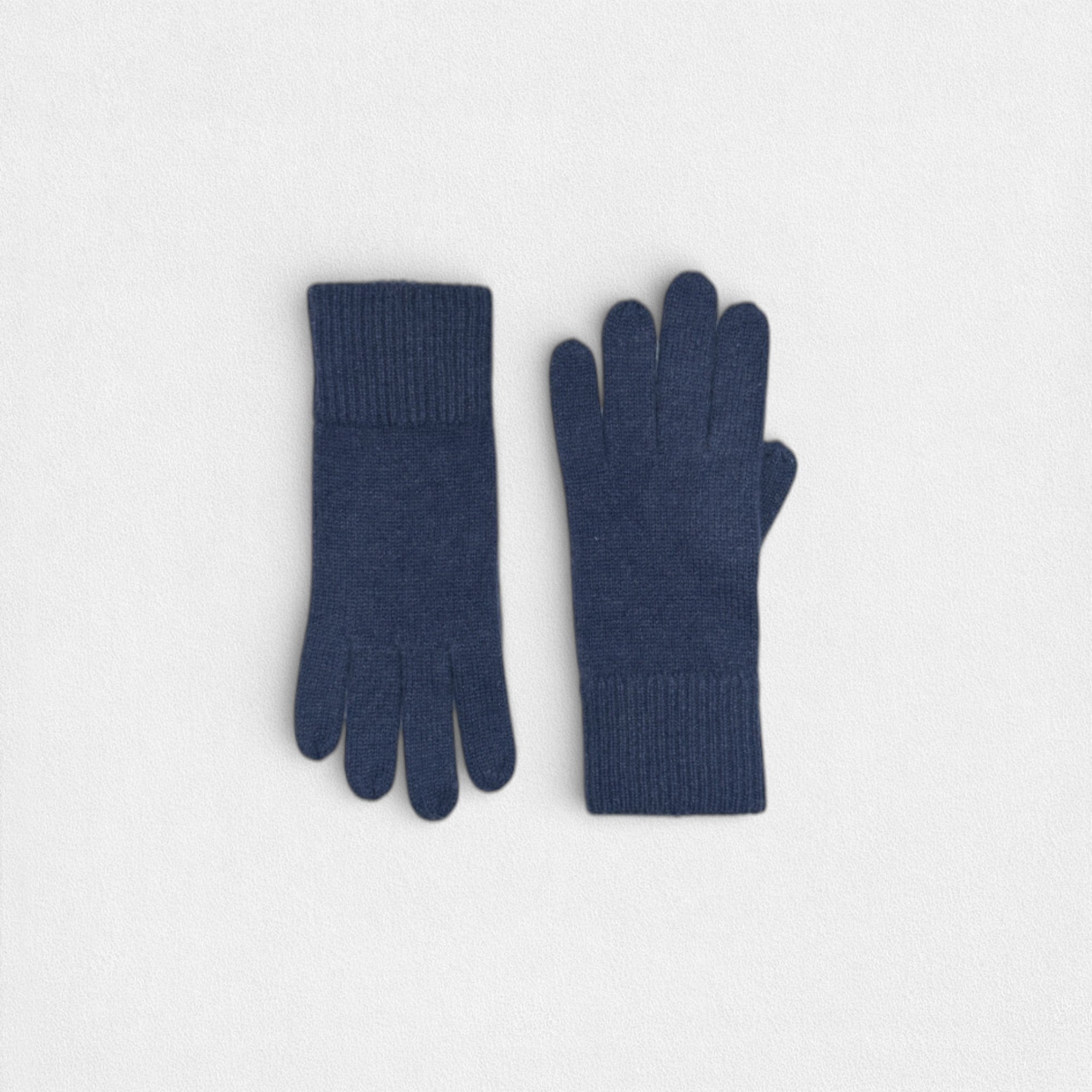 Navy 100% cashmere gloves a white background.