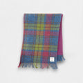 A Harris Tweed scarf with Isle of Skye Tartan pattern, featuring a blend of soft blues, greens, reds, and purples, with fringing on the edges.