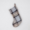 A Christmas stocking with MacKellar tartan, primarily in brown and grey, hanging against a white background.