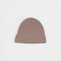 Neutral pink tone cashmere beanie on white background.