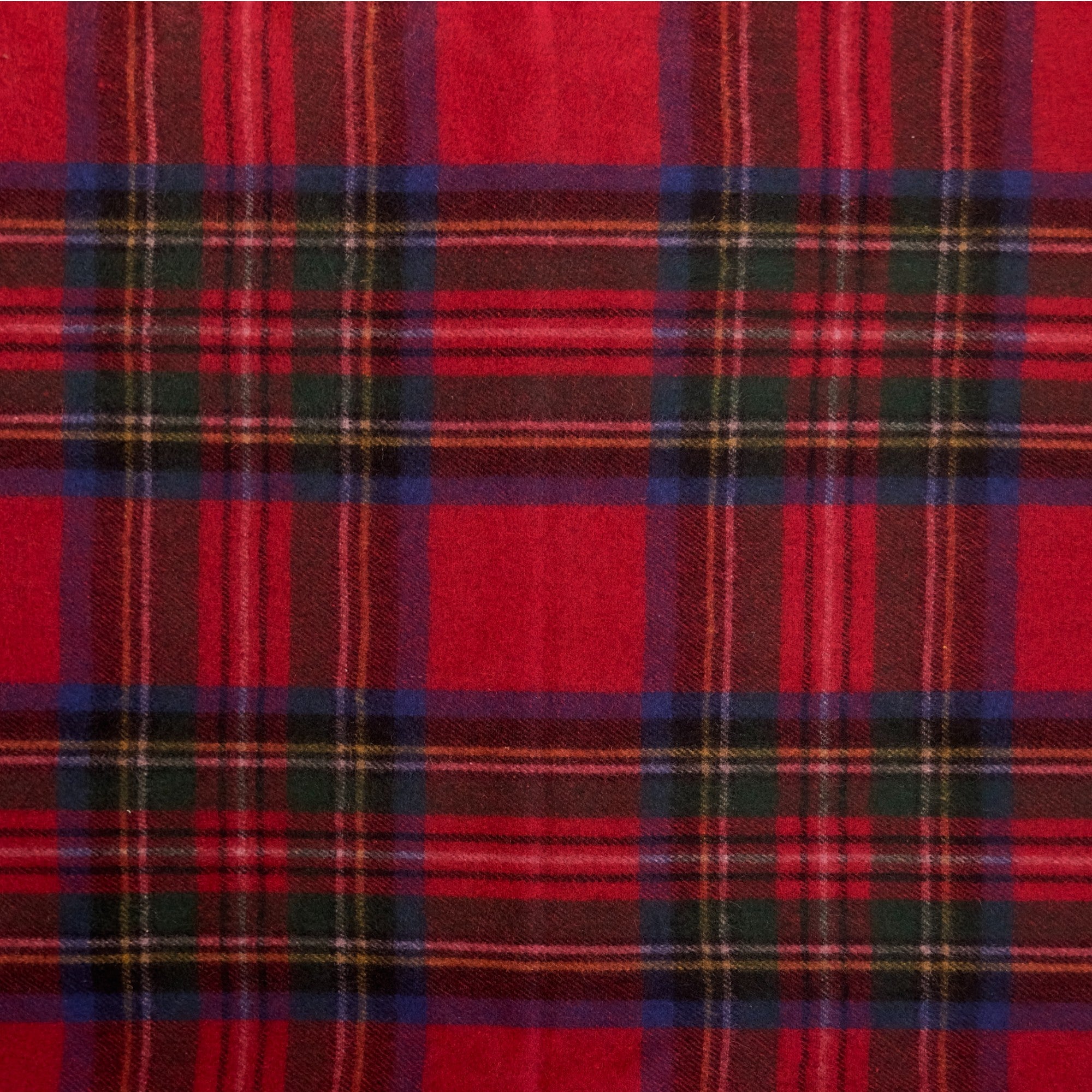 A close up of the Royal Stewart tartan, the Royal Stewart tartan has red, blue, yellow and green in a checkered pattern.