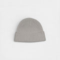 Light grey ribbed cashmere beanie with a minimalist design, photographed on a white background.