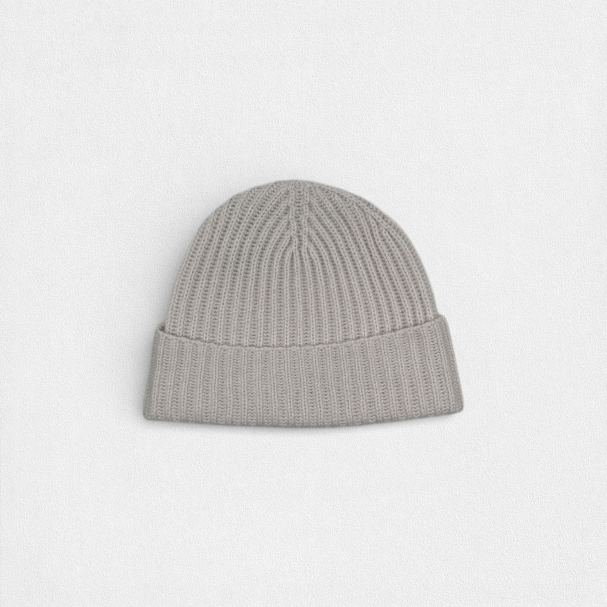 Light grey ribbed cashmere beanie with a minimalist design, photographed on a white background.