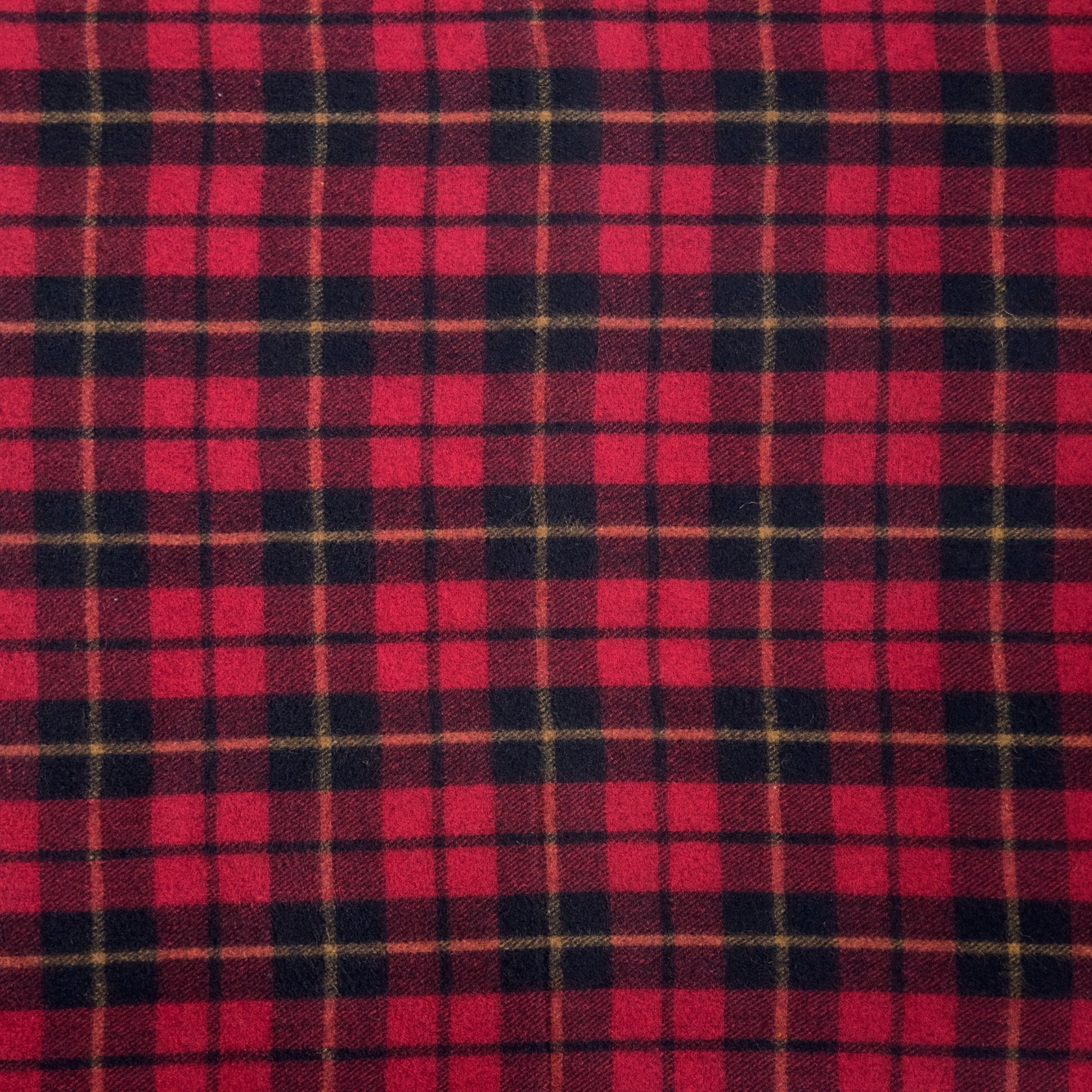 A close up shot of the Wallace tartan. Wallace tartan has a red, black and yellow checkered pattern.