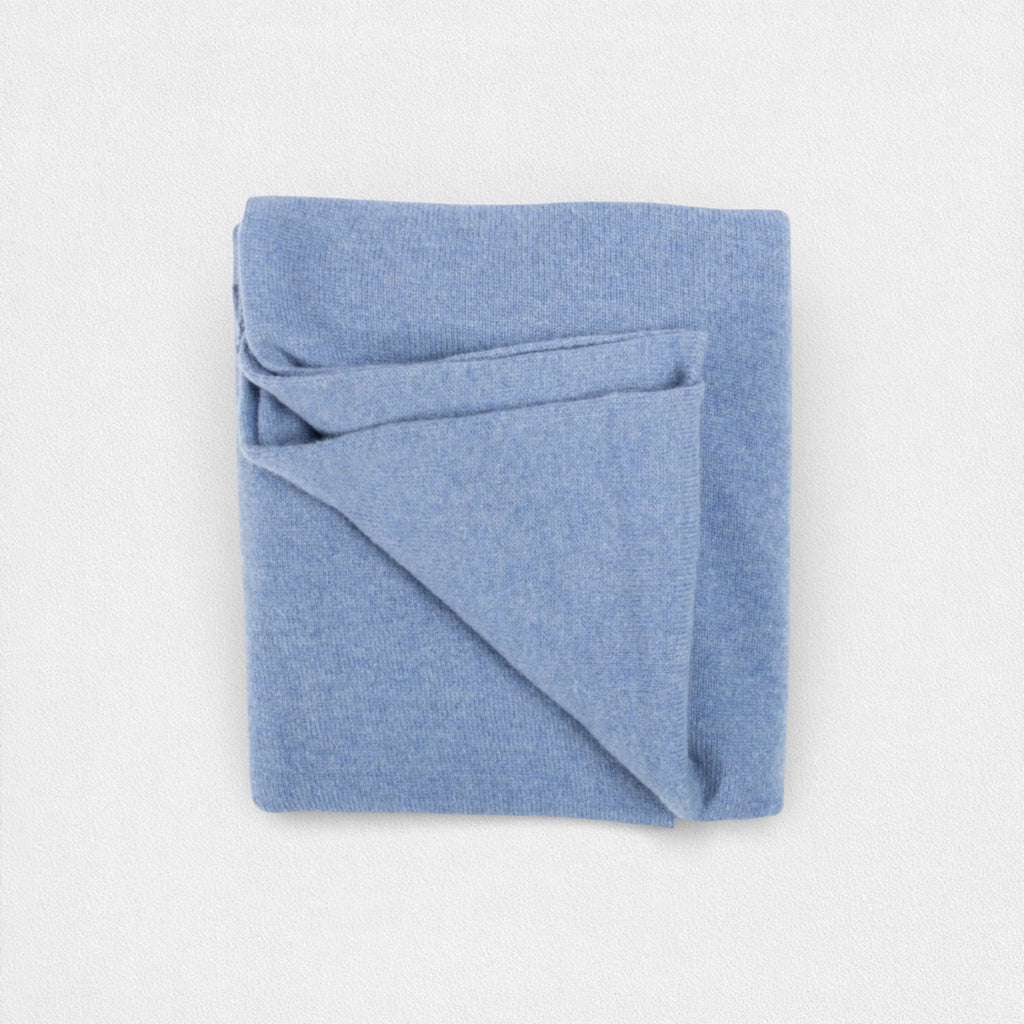 Folded blue neck wrap on a light gray background