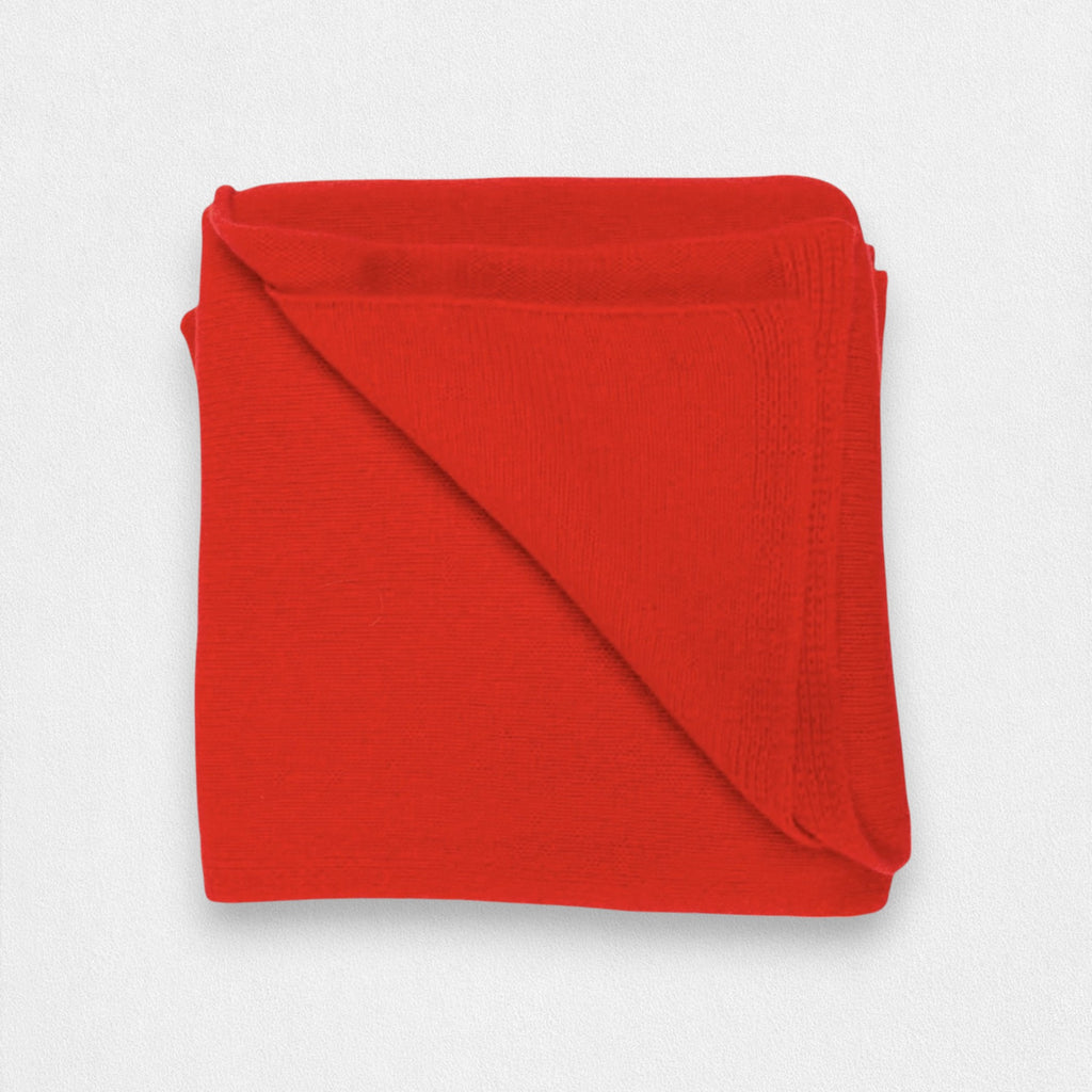 A folded red cashmere blanket displayed on a white background.