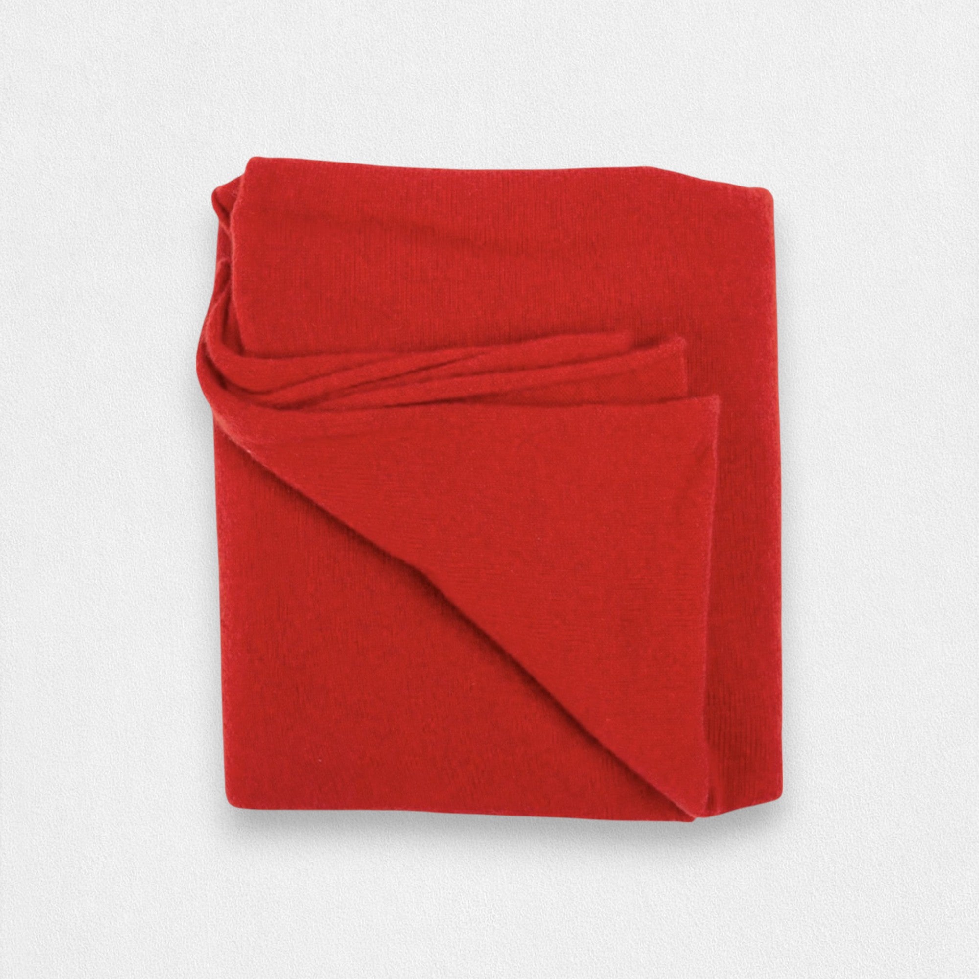 A folded red cashmere scarf displayed on a plain background.